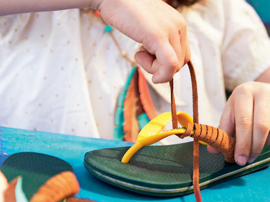 Plastikriemen vom Flipflop wird mit einem Lederband umwickelt.