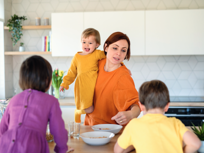Mother with children in the kitchen