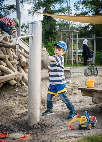 Junge spielt auf dem Spielplatz